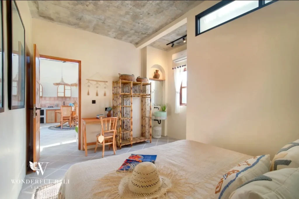 Second bedroom with desk and bamboo screen opening to the living room in a 2-bedroom villa in Buduk Canggu Bali