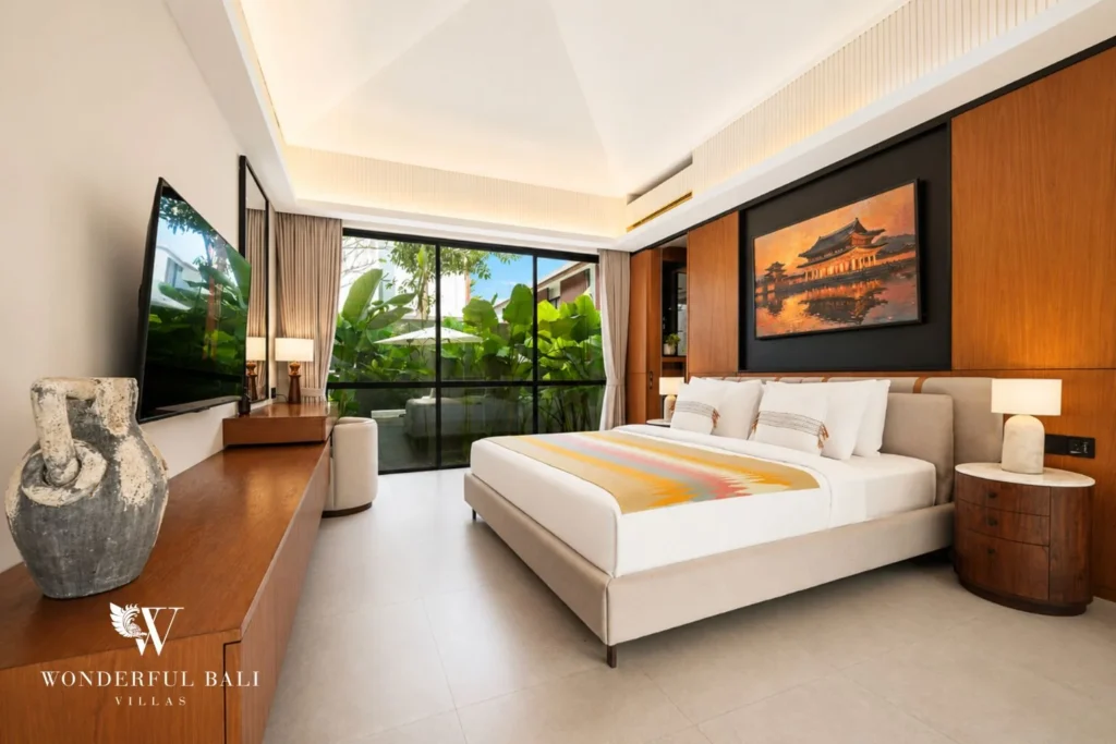 Bedroom with smart TV and floor-to-ceiling garden doors in a 3-bedroom villa in Jimbaran Bali