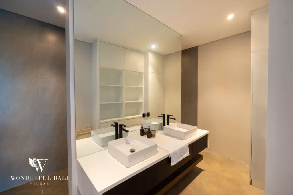 4BR villa for rent in Seminyak — bathroom, twin basins on a dark vanity with open shelving