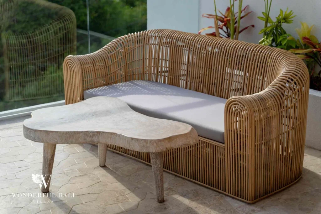 Curved rattan daybed and carved stone table on a terrace near Nusa Dua Bali