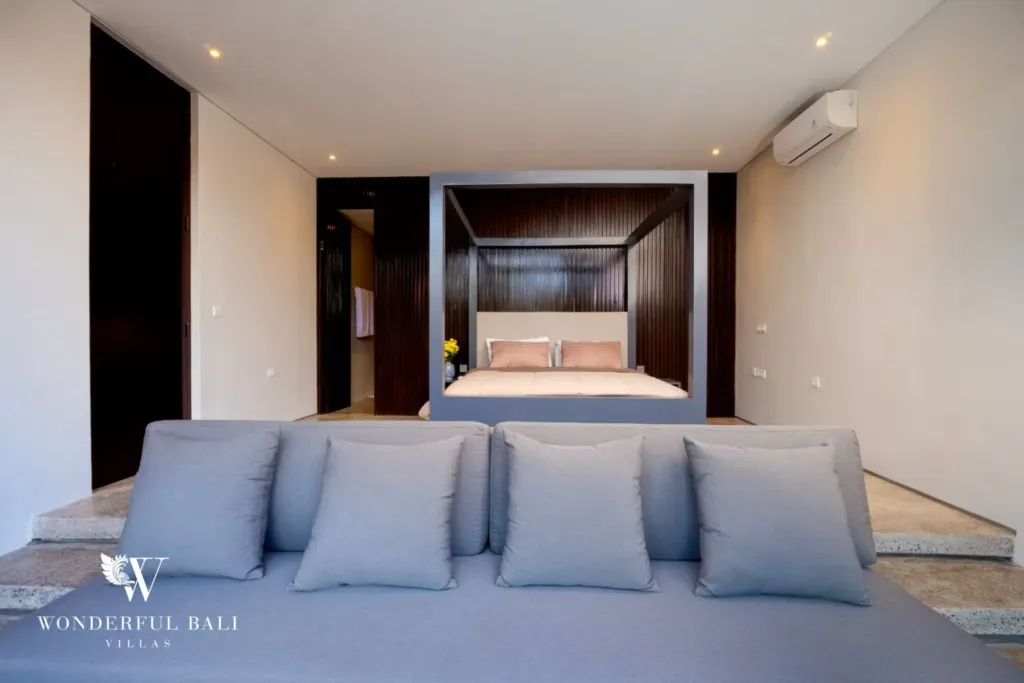 4BR villa for rent in Seminyak — bedroom, bed in a timber-lined alcove seen across the daybed