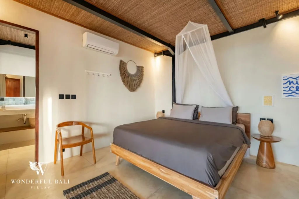 King bed under a draped mosquito net in a 5-bedroom villa in Uluwatu Bali