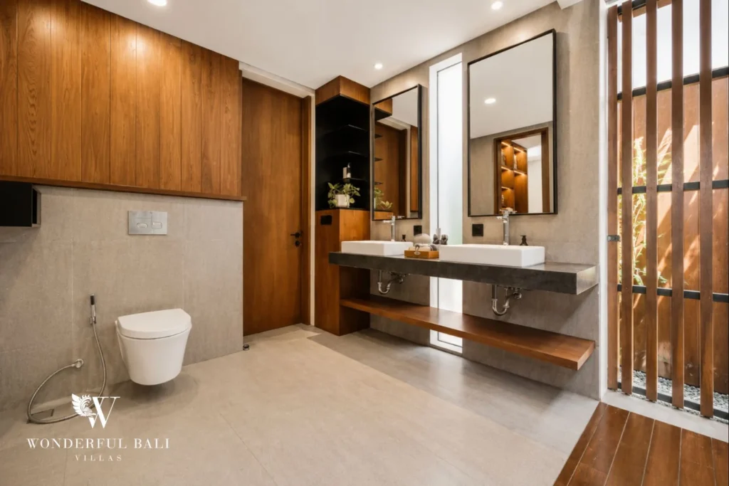 Bathroom with stone vanity, mirror and slatted timber screen in a 3-bedroom villa in Jimbaran Bali