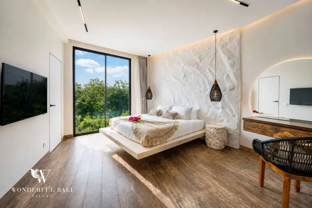 Main bedroom with floating platform bed against a textured plaster wall near Nusa Dua Bali