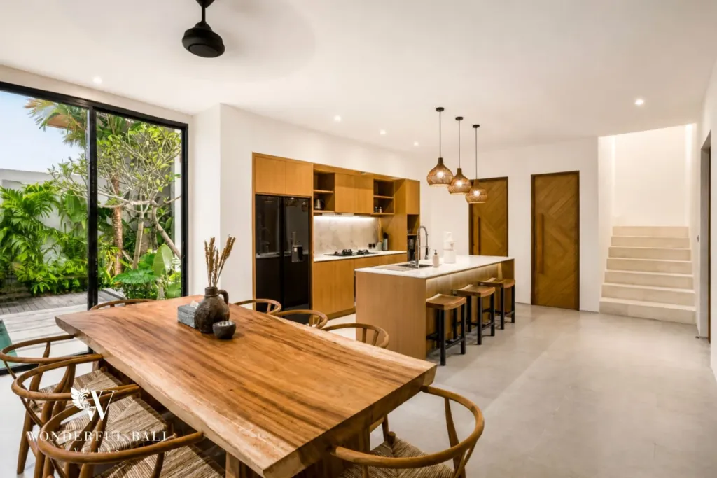 4BR villa for rent in Pererenan — dining, live-edge timber table for six beside the kitchen