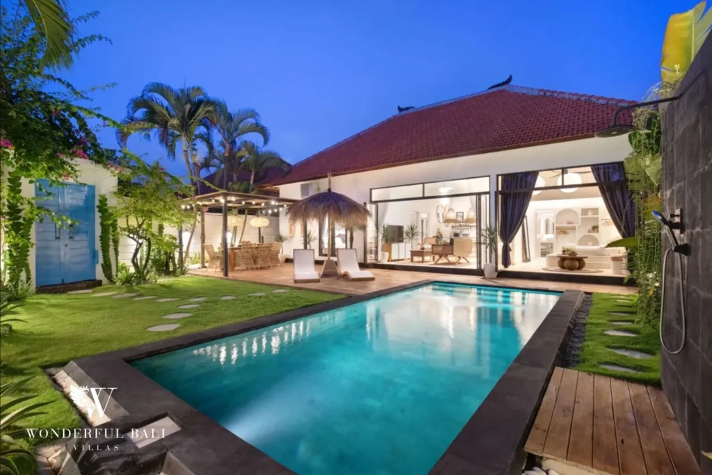 Villa and lit lap pool at dusk at a 3-bedroom villa in Umalas Bali