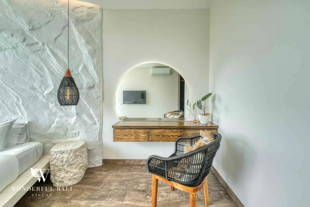 Bedroom dressing area with round mirror and timber console near Nusa Dua Bali