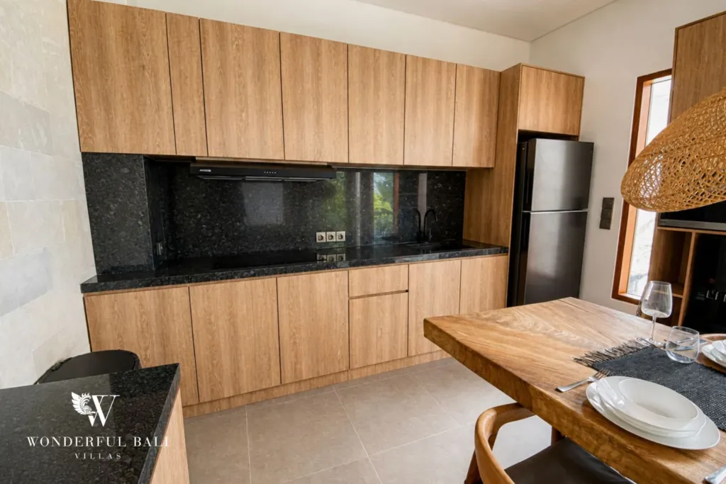 3BR villa for rent in Kedungu — kitchen, fitted timber kitchen with a stone worktop and fridge