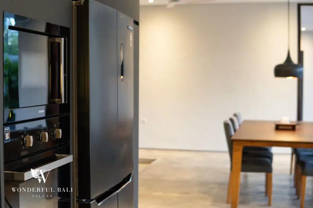 4BR villa for rent in Seminyak — kitchen, oven, fridge and the dining table beside it