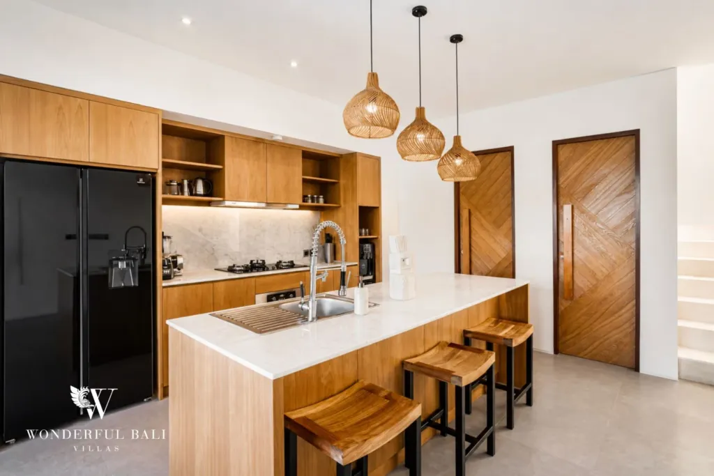 4BR villa for rent in Pererenan — kitchen, marble island with bar stools and timber cabinetry