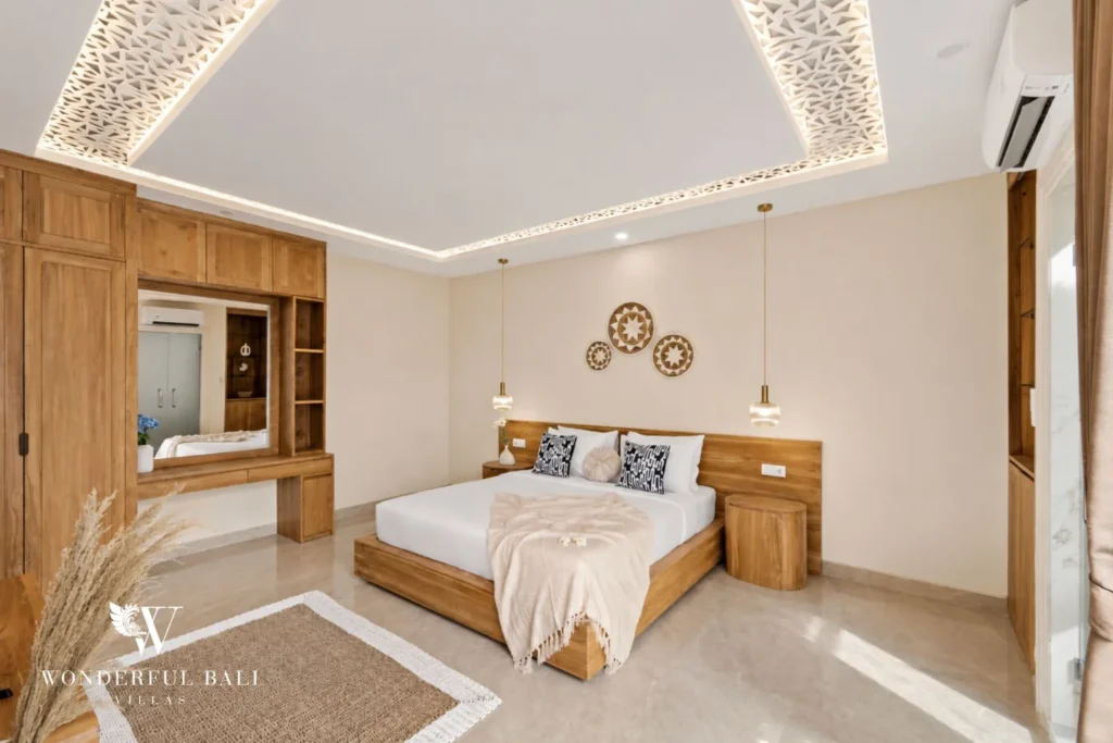 Second bedroom with teak wardrobe and dressing table in a 3-bedroom villa in Tumbak Bayuh Bali
