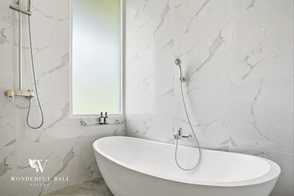 Marble bathroom with rain shower and freestanding tub in a 3-bedroom villa in Kaba-Kaba Bali
