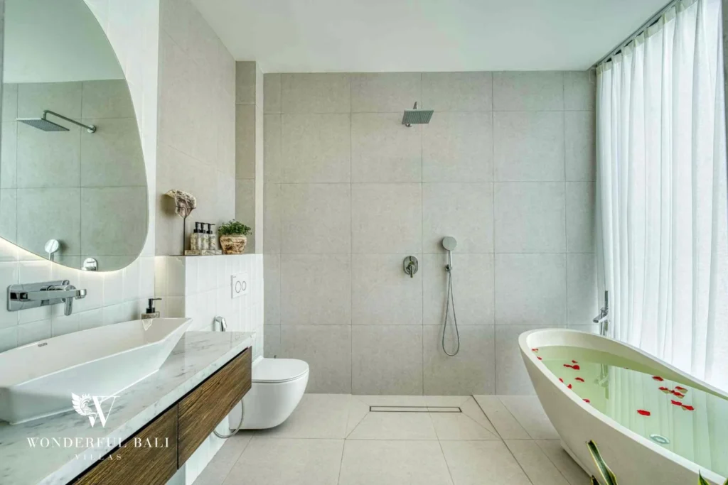 En-suite bathroom with twin vanity, rain shower and freestanding tub near Nusa Dua Bali