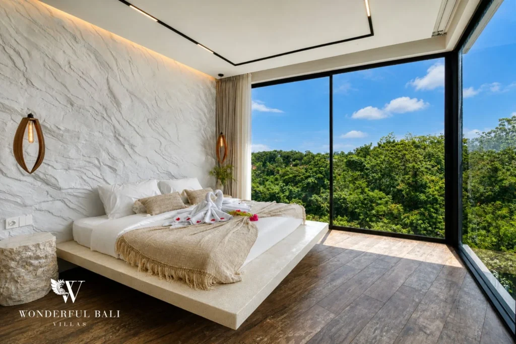 Bedroom with full-height glass over the treetops in a 3-bedroom villa near Nusa Dua Bali