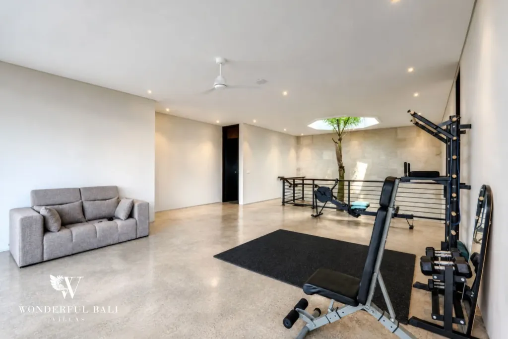 4BR villa for rent in Seminyak — gym, large upper-floor room set up with a rack and bench