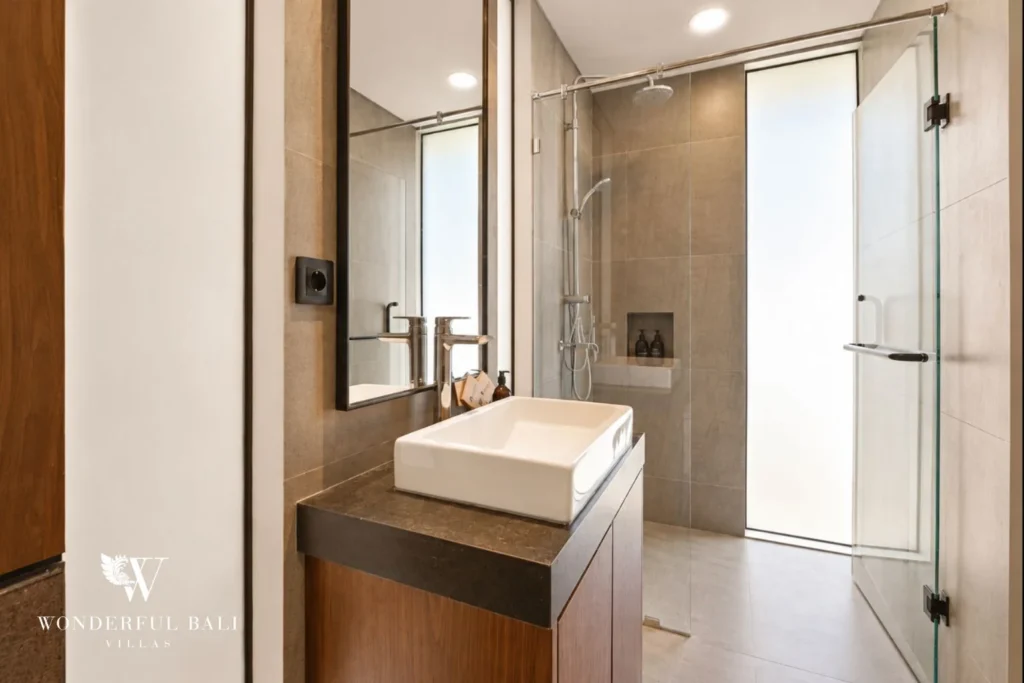 En-suite bathroom with vessel basin and walk-in rain shower in a 3-bedroom villa in Jimbaran Bali
