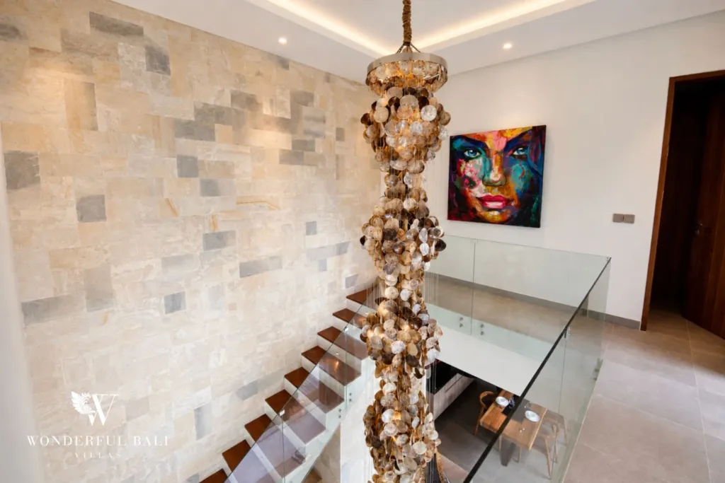3BR villa for rent in Kedungu — staircase, shell chandelier hanging through the stairwell