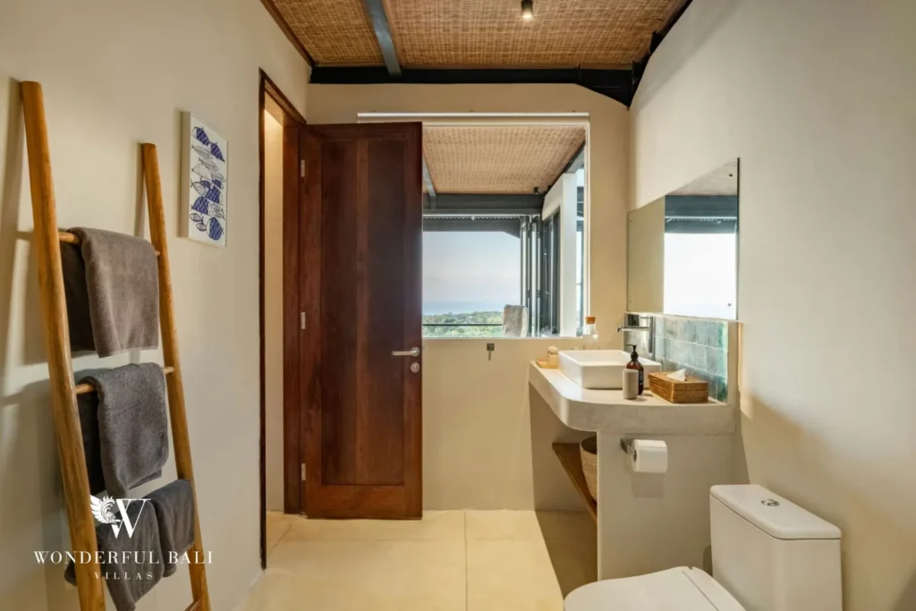 Bathroom with terrazzo vanity and a window onto the sea in a 5-bedroom villa in Uluwatu Bali