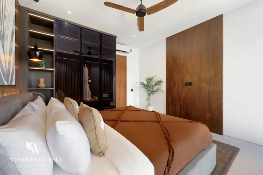 Bedroom with open wardrobe and reading lights at a 3BR villa in Pererenan Bali