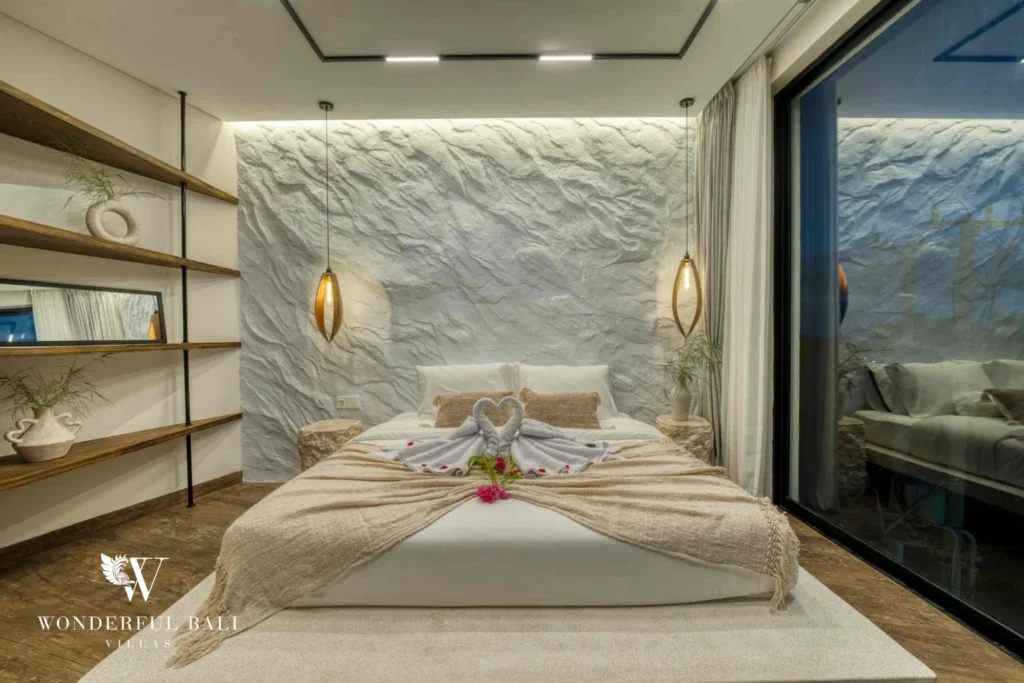 Bedroom with open timber shelving and a textured plaster headboard wall near Nusa Dua Bali