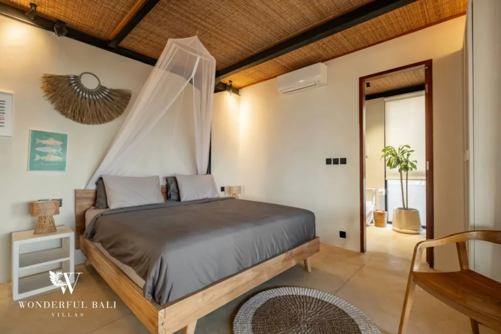 Bedroom with rattan ceiling and en-suite beyond in a 5-bedroom villa in Uluwatu Bali