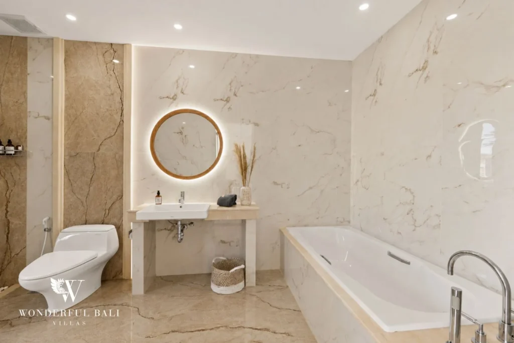 En-suite bathroom with marble tub and lit mirror in a 3-bedroom villa in Tumbak Bayuh Bali