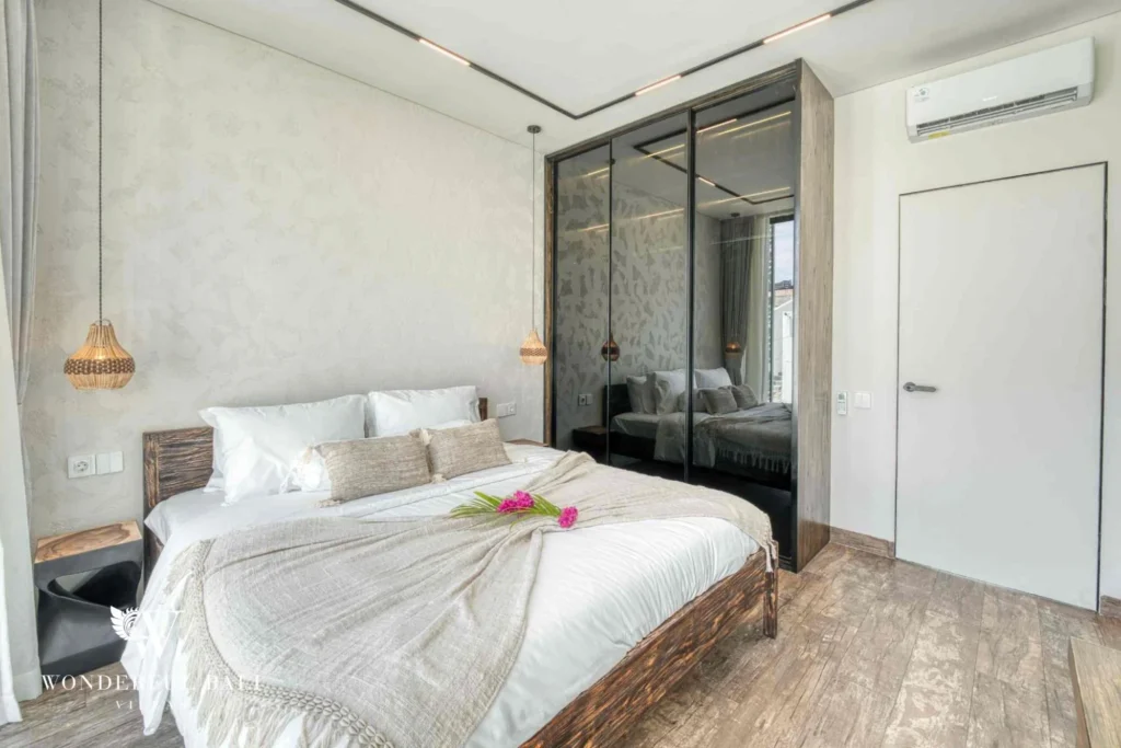 Third bedroom with timber headboard and glazed wall in a 3-bedroom villa near Nusa Dua Bali