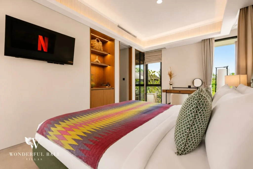 Third bedroom with smart TV and open shelving in a 3-bedroom villa in Jimbaran Bali