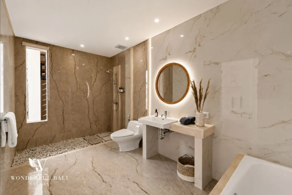 En-suite with pebble-floored marble shower in a 3-bedroom villa in Tumbak Bayuh Bali