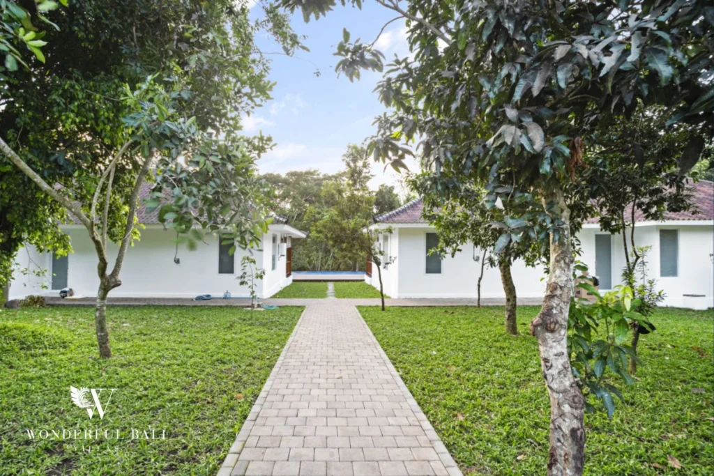 Paved path between two pavilions leading to the pool at a 3-bedroom villa in Kaba-Kaba Bali