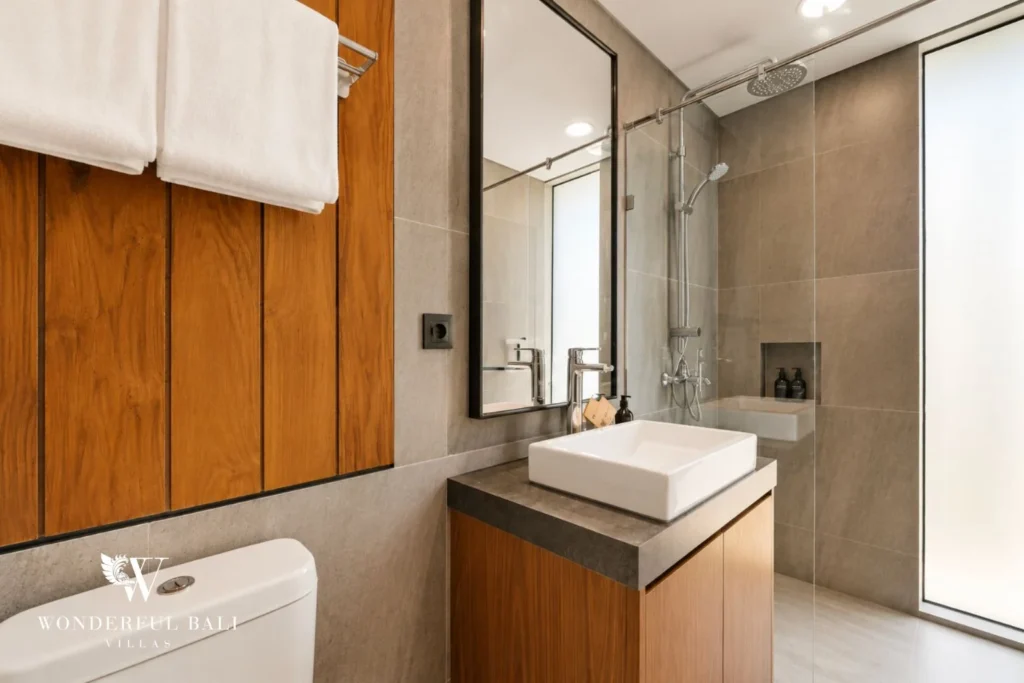 En-suite bathroom with vessel basin and glass shower in a 3-bedroom villa in Jimbaran Bali