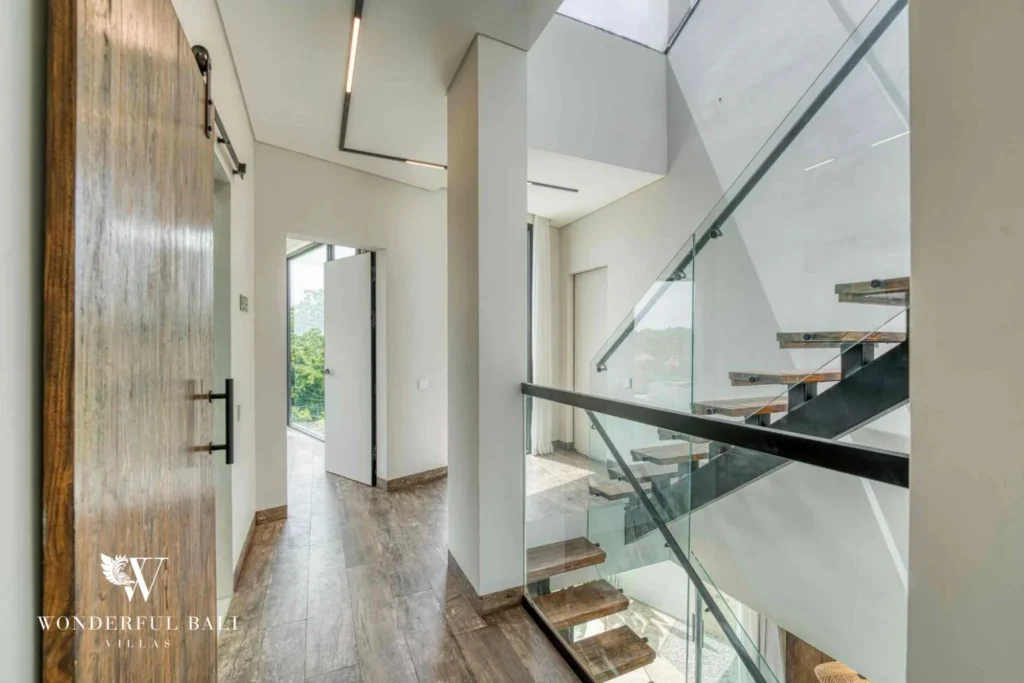 Upper landing with glass balustrade above the stair in a 3-bedroom villa near Nusa Dua Bali