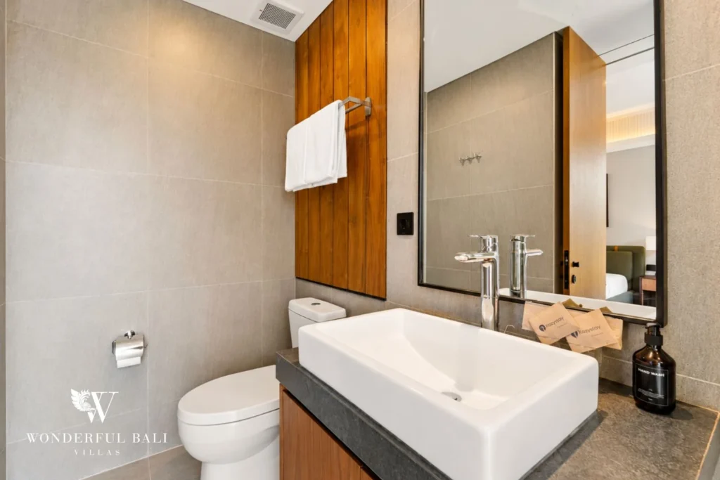 Bathroom vanity with oak panelling and mirror in a 3-bedroom villa in Jimbaran Bali