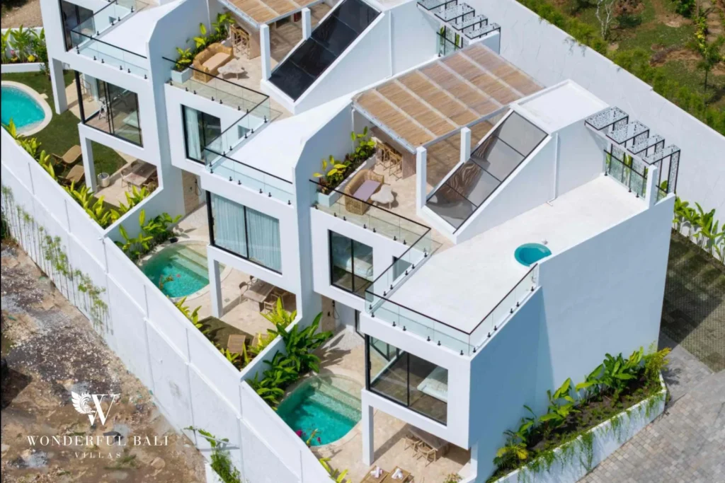 Aerial view of the gated terrace of white villas with private pools near Nusa Dua Bali