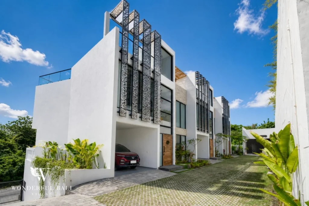 Street facade of the white gated villa terrace with private parking near Nusa Dua Bali