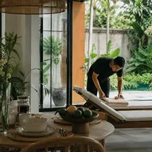 Wonderful Bali Villas staff preparing the pool area at dusk