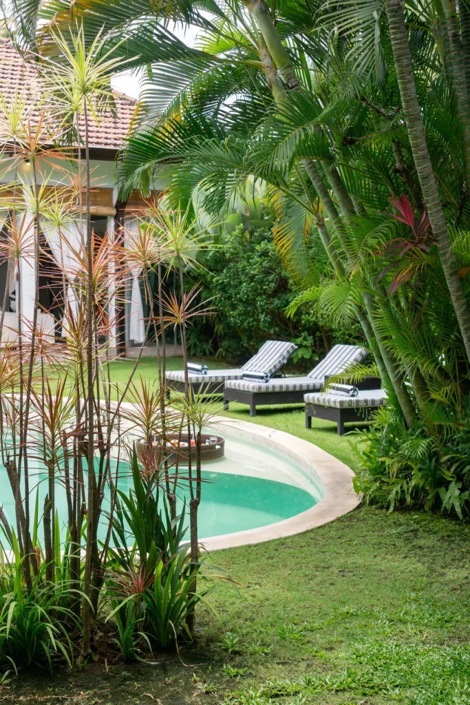 Villa Alice Dua, Seminyak — garden, sun loungers on the lawn under palms at Villa Alice Dua