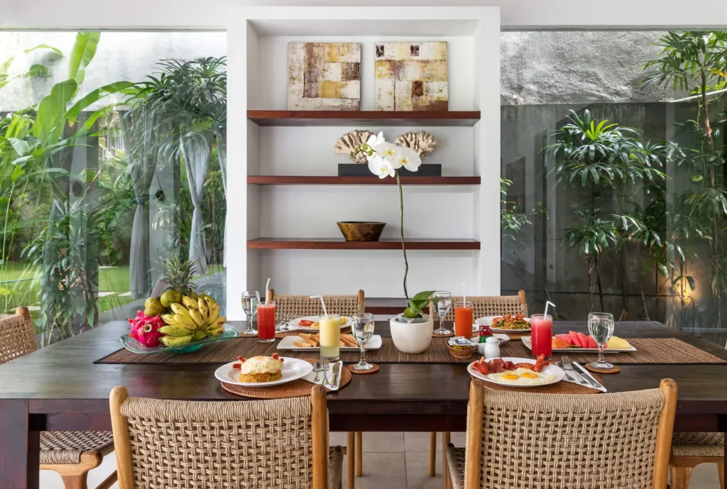 Villa Alice Dua, Seminyak — dining, backed by open timber shelving at Villa Alice Dua