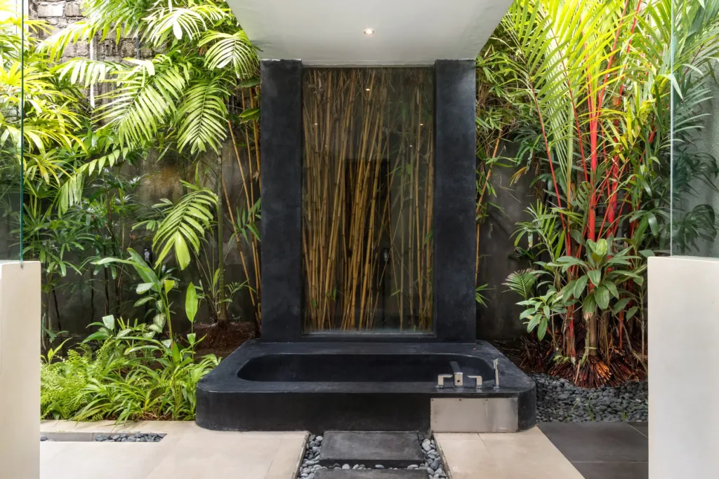 Villa Alice Dua, Seminyak — bathroom, sunken black granite bathtub in a bamboo-planted courtyard at Villa Alice Dua