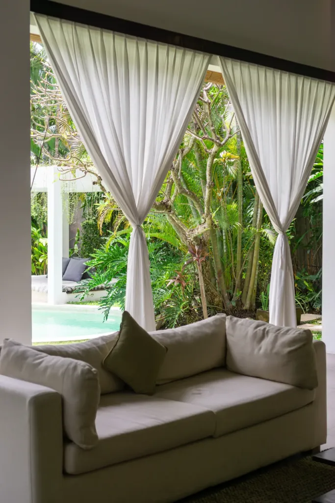 Villa Alice Dua, Seminyak — living room, covered seating looking onto the garden at Villa Alice Dua