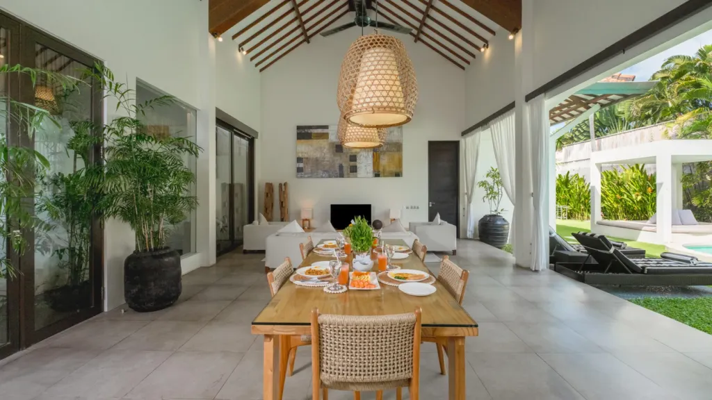 Open-plan dining table looking out to the pool at Villa Alice Satu