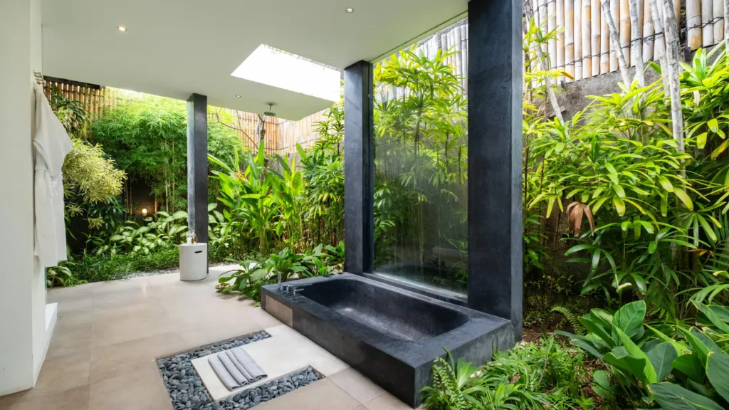 Sunken stone bathtub in a planted semi-open courtyard at Villa Alice Satu