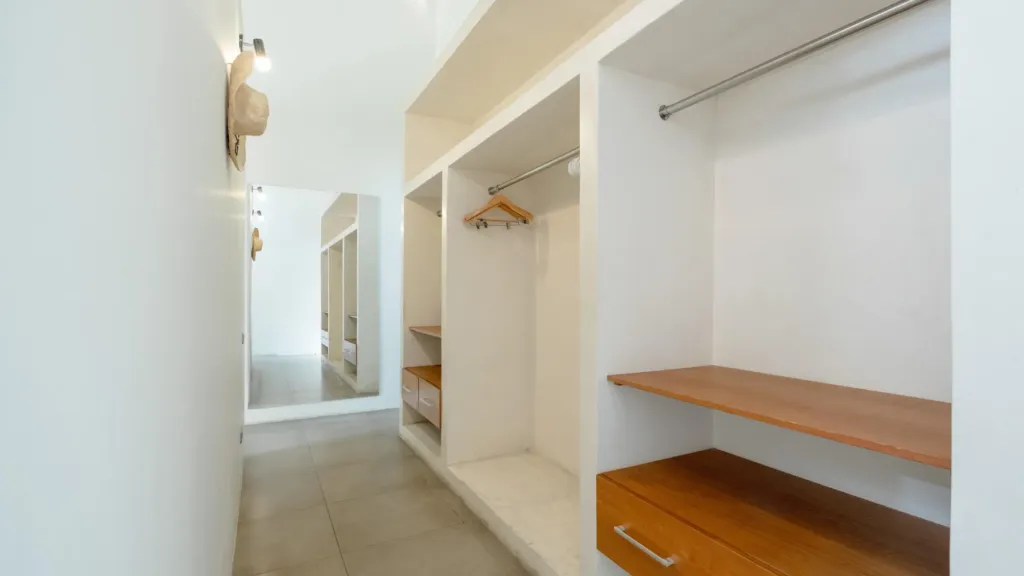 Walk-in wardrobe with hanging space and shelving at Villa Alice Satu