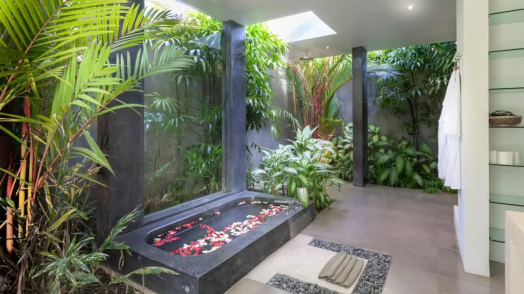 Stone bathtub dressed with flower petals at Villa Alice Satu