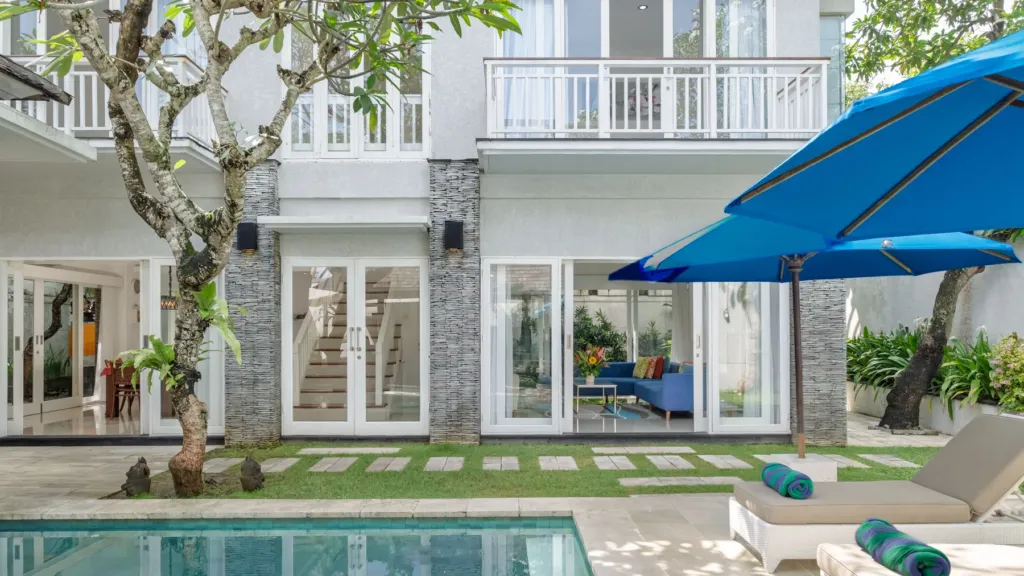 Villa Alun, Batu Belig — exterior, the two-storey villa and pool seen across the lawn