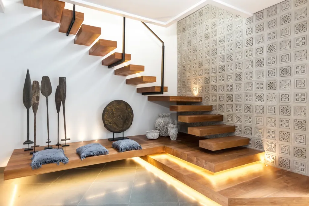 Floating timber staircase and carved artefacts at Villa Castil di Udara