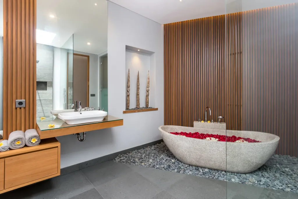 Villa Castil di Udara, Kerobokan — bathroom, stone bathtub set on river pebbles in an en-suite at Villa Castil di Udara