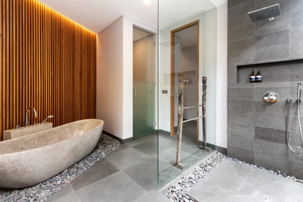 Villa Castil di Udara, Kerobokan — bathroom, stone bathtub and walk-in shower in an en-suite at Villa Castil di Udara