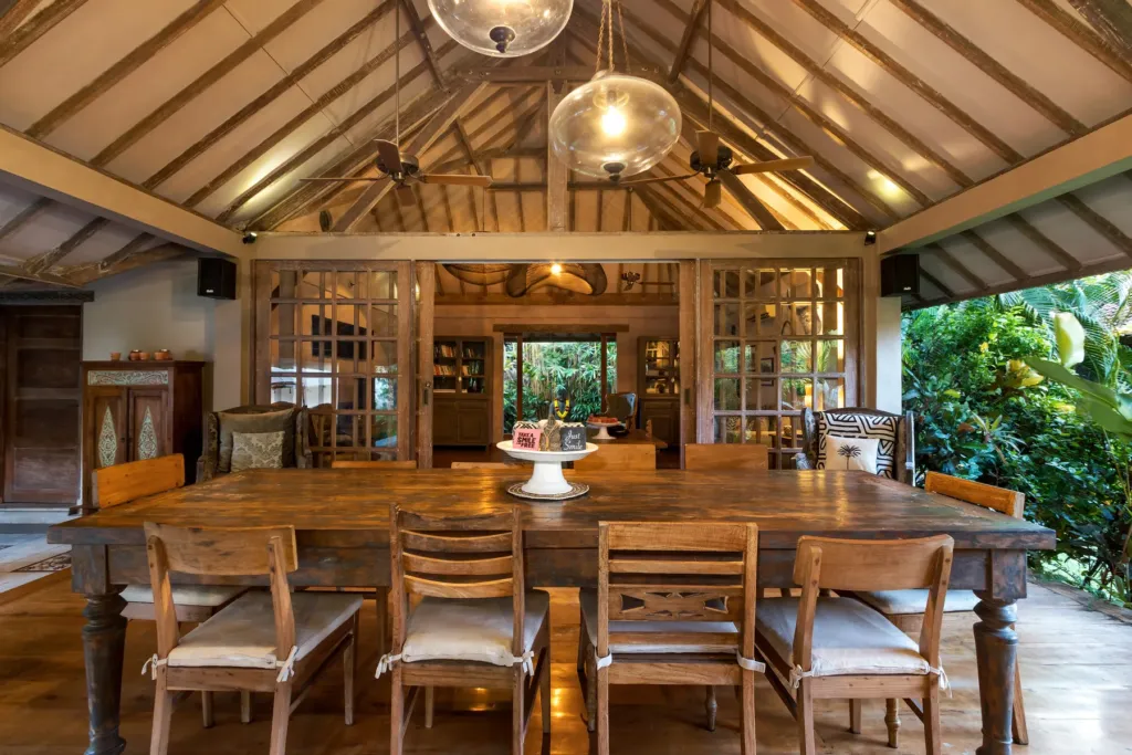 Teak dining table for ten under the high Balinese roof at Villa Koyama