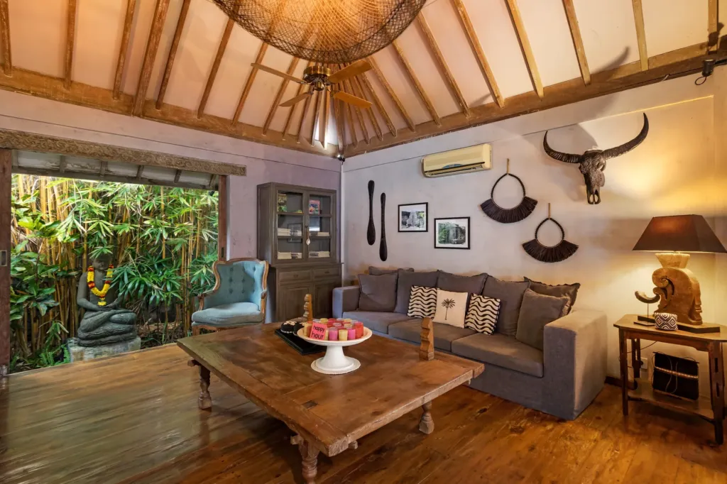 Air-conditioned media room at Villa Koyama with deep sofas and artwork